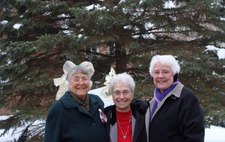 Sister Fidelis Rubbo, Sister Ann Carmen Barone and Sister Magdala Davlin stand in front of Jubilee, the mighty tree